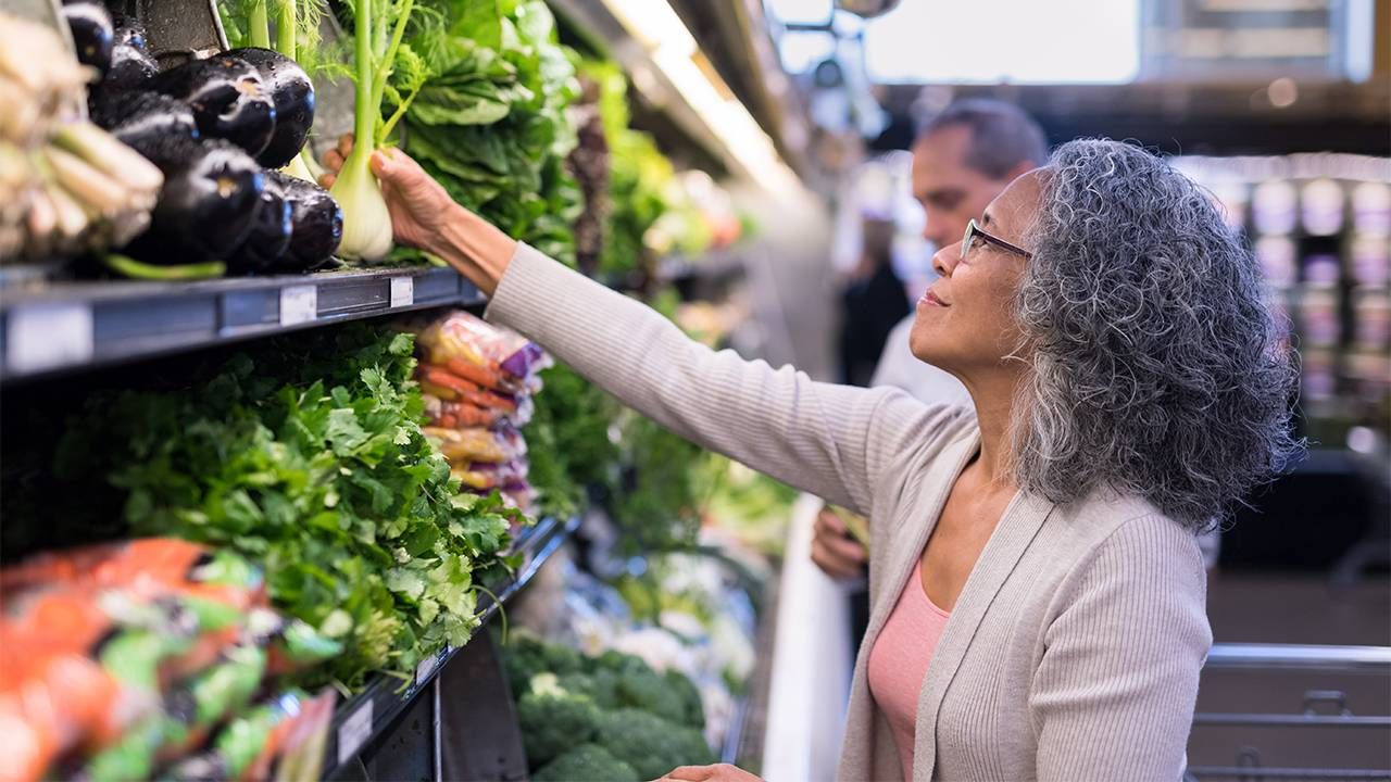 A woman shopping at the grocery store. Inflation, money, finances, Next Avenue