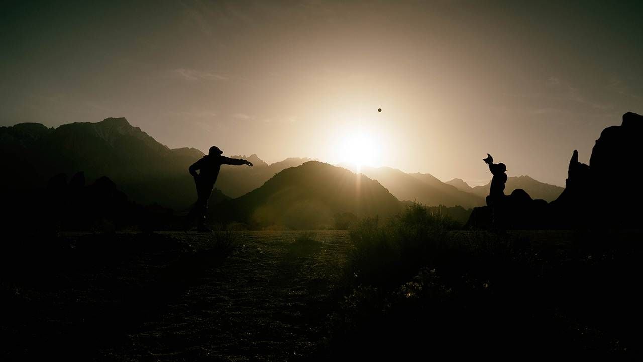 A silhouette of a father and son playing catch. Dad, father's day,Next Avenue