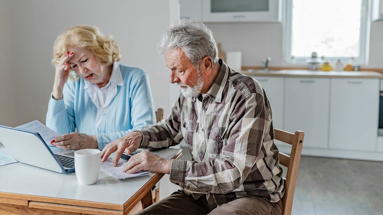 A couple sitting down looking at finances. Low income, the elder index,, Next Avenue