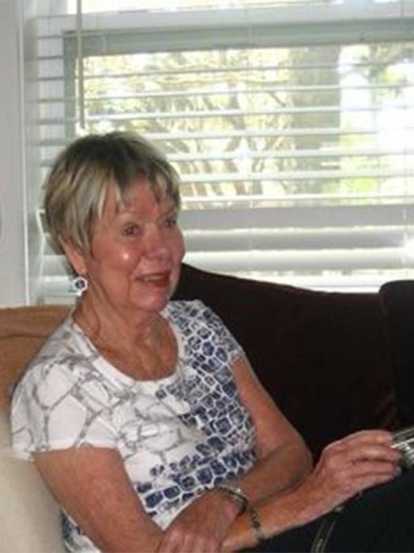 An older woman sitting at home in front of a window. Guardianship, Next Avenue, eldercaring coordination