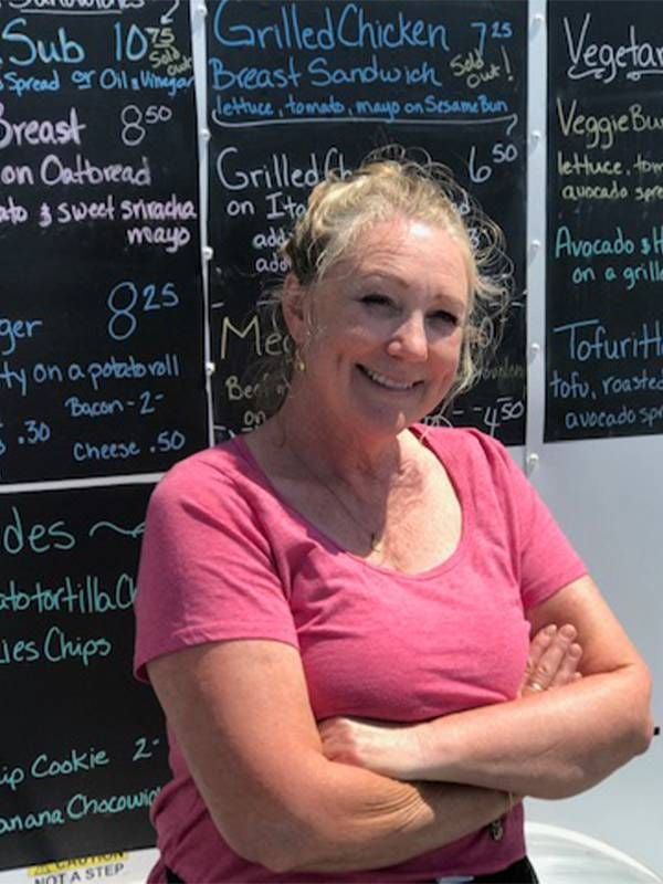 A woman standing in front of a food truck. Next Avenue, pivot