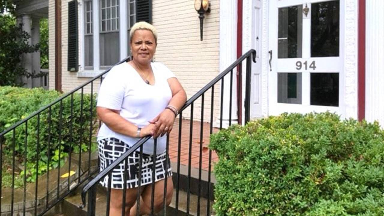 A woman standing on the front steps of a B&B. Next Avenue, Black and Latina women, COVID-19 pandemic