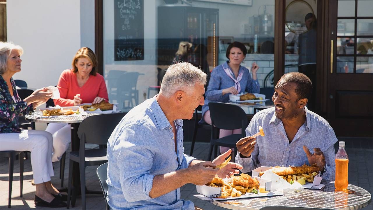 A group of friends dining outside in the sun. Sun exposure, Next Avenue