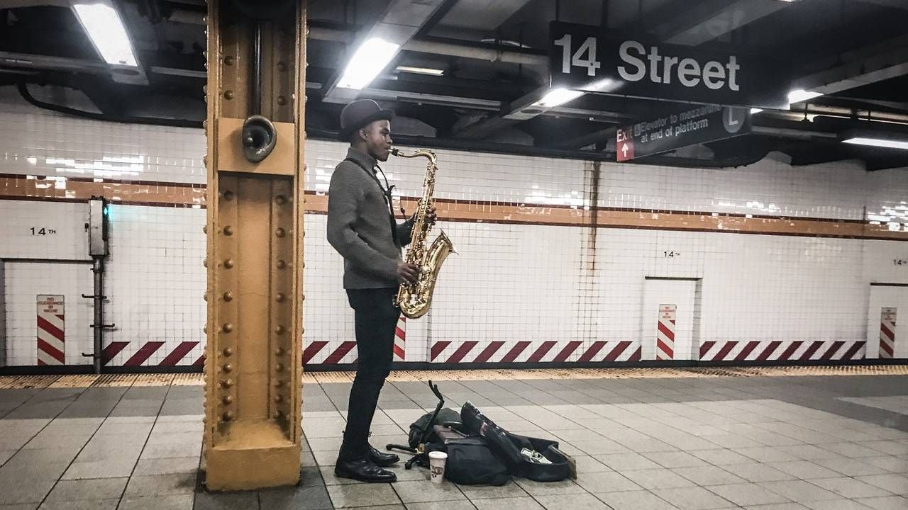 A saxophone player at the 14th Street subway stop. photography, photographer, Next Avenue