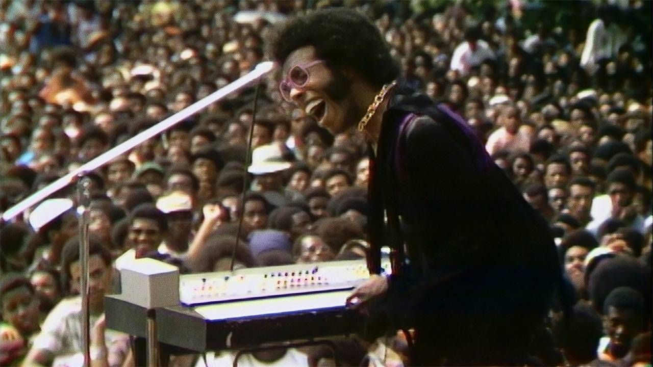 Sly Stone performing at a festival. Questlove, Summer of Soul, Next Avenue