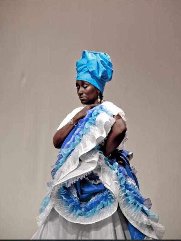 A woman wearing a blue and white gown. Mardi gras indians, dancing, Next Avenue