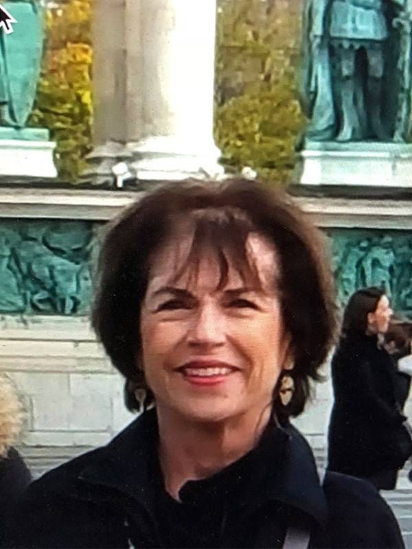 A woman standing outside, smiling. finding a doctor, Next Avenue