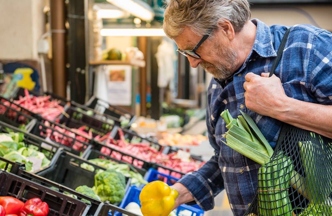 A man shopping at the grocery store. Next Avenue, solo aging