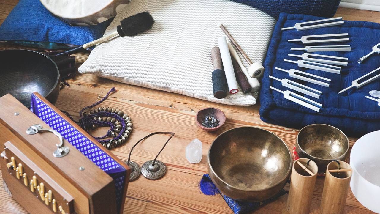 Pillows, brass bowls, quartz bowls, bamboo tubes, and bells. Sound bath, Next Avenue, stress