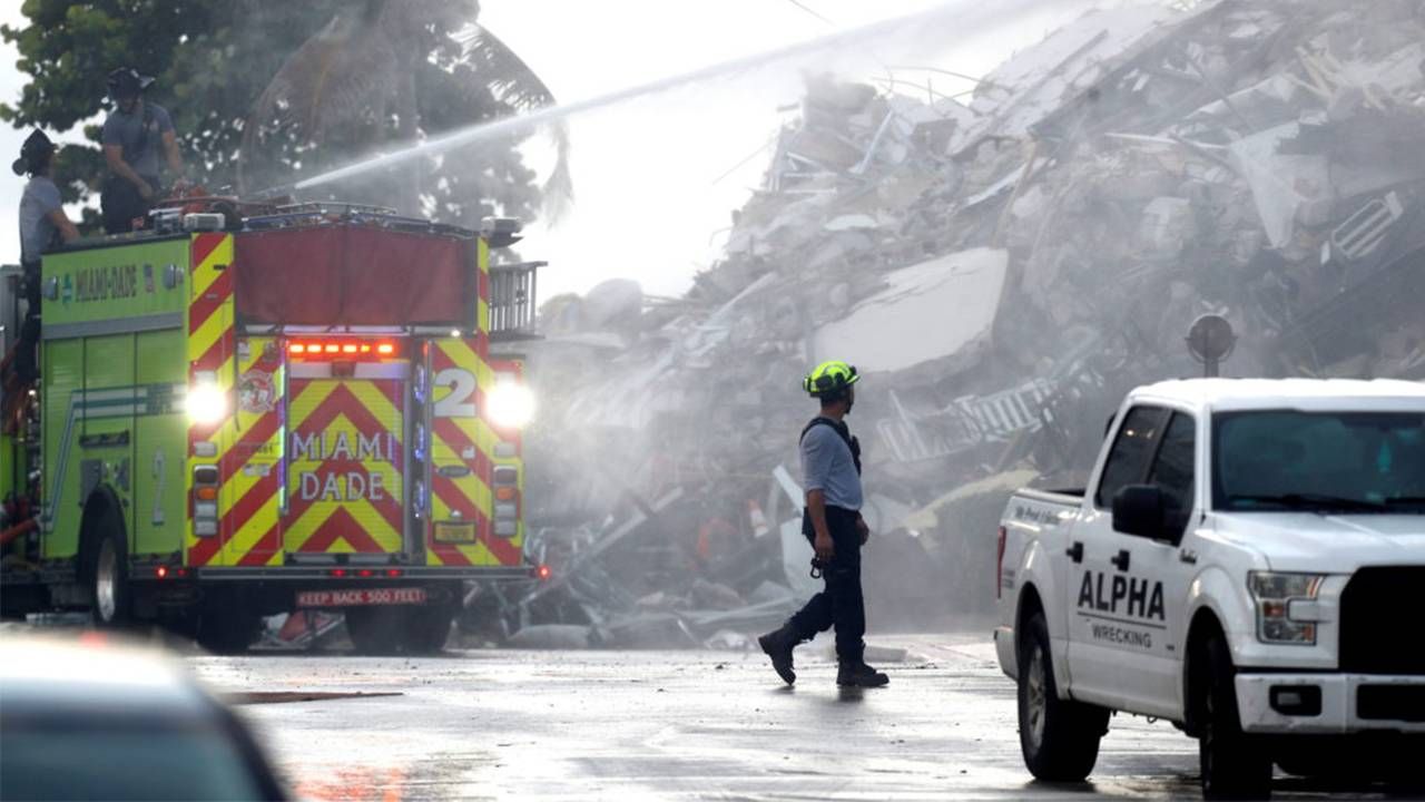 Clean up crews and firefighters at the Surfside condo building collapse. Next Avenue, building safety