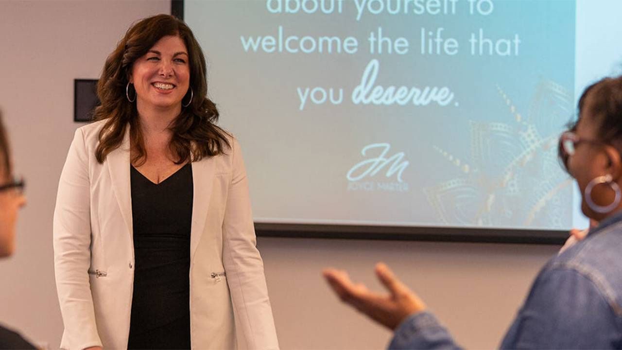 Joyce Marter author of "The Financial Mindset Fix" speaking at an event. Mental health, financial health, Next Avenue