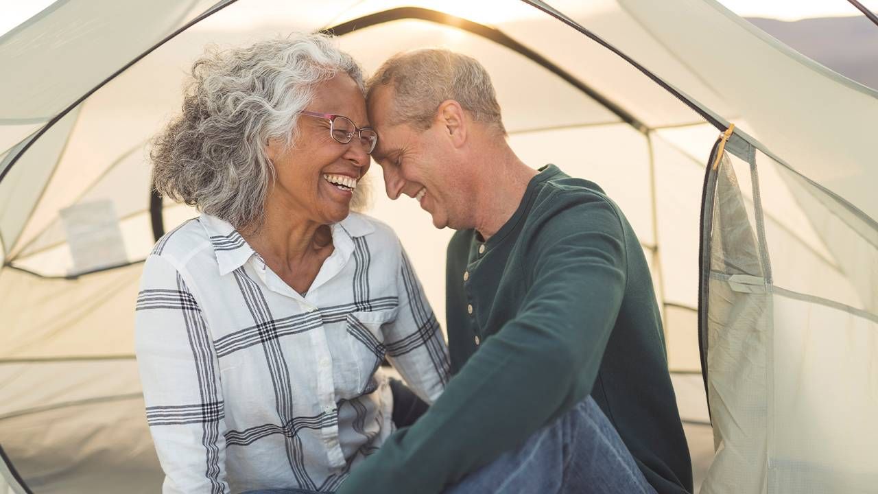 A couple embracing affectionately in a tent. Next Avenue, libido, sex