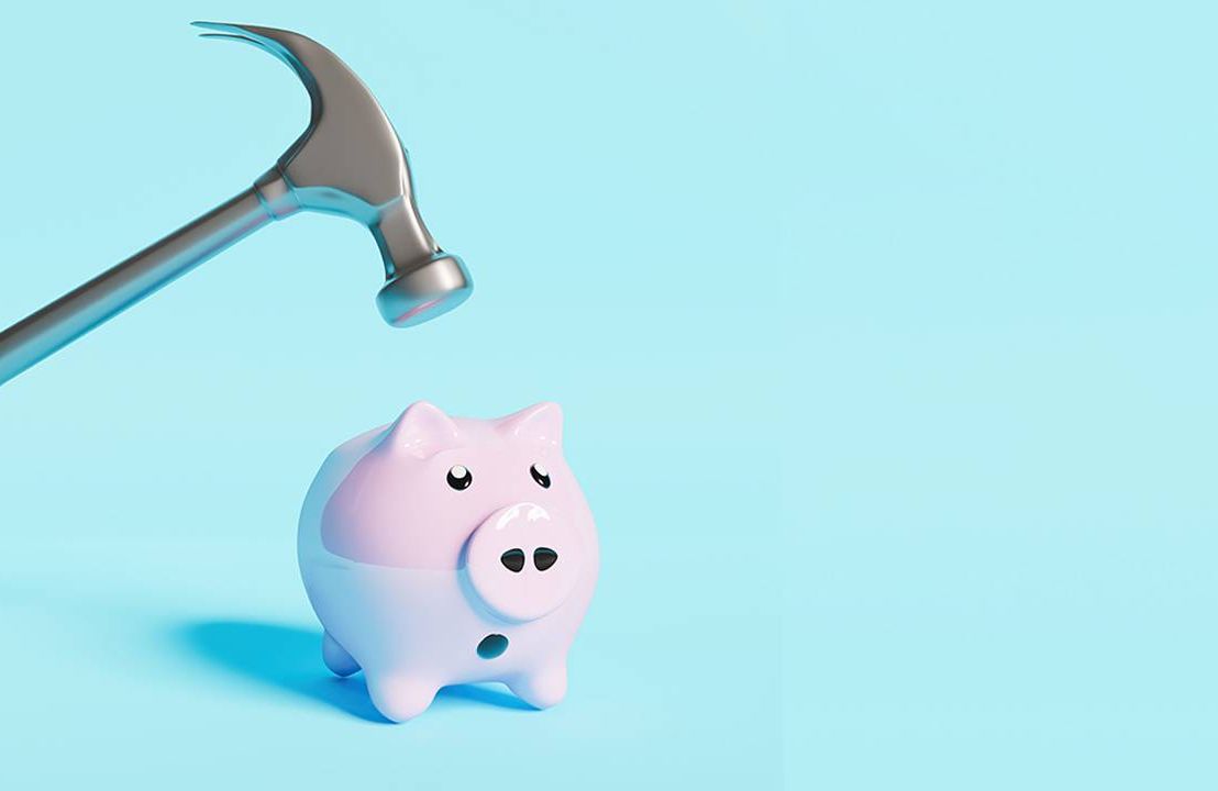 A hammer hovering over a worried piggy bank. Next Avenue, retirement, 401k