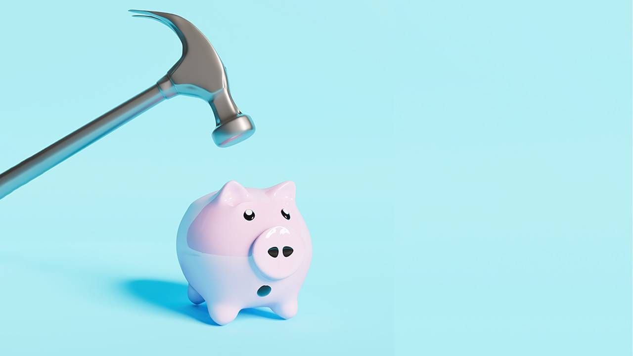 A hammer hovering over a worried piggy bank. Next Avenue, retirement, 401k