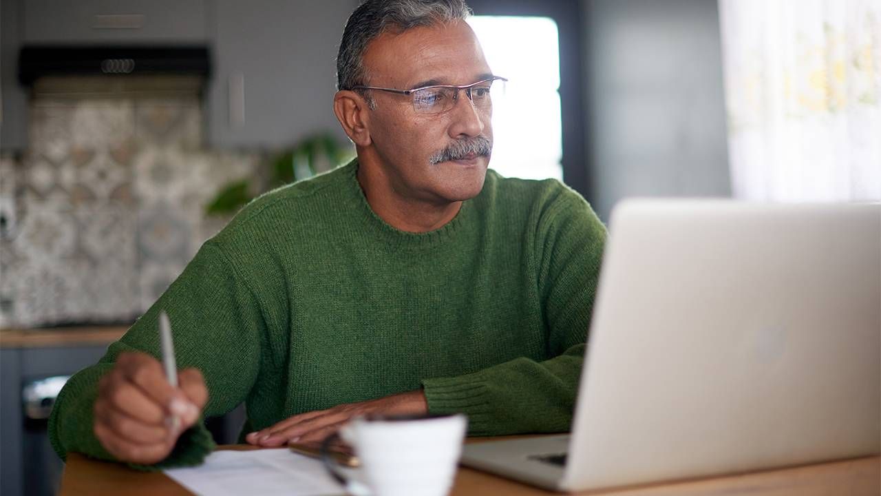 A man working in digital marketing on his computer. Next Avenue