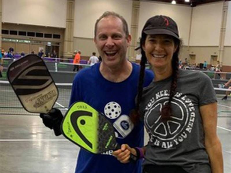 The author holding a pickleball racket. Next Avenue, take a leap