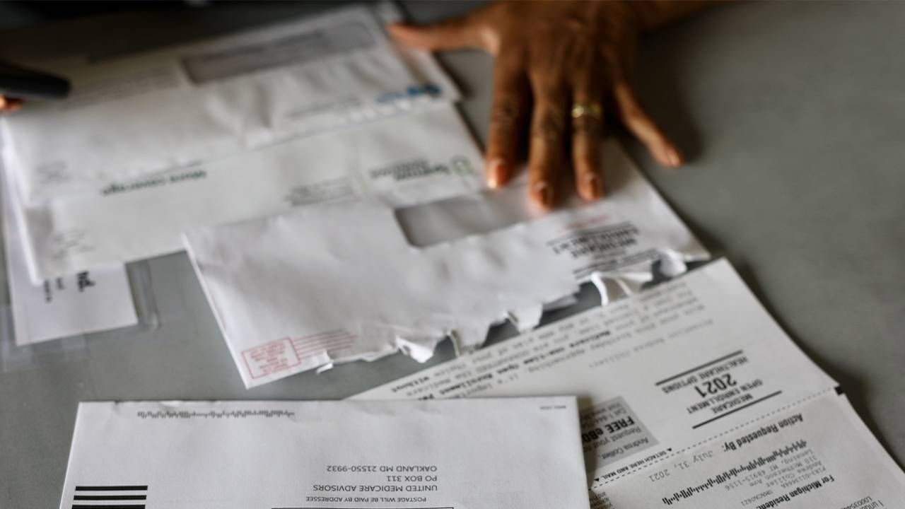 Andrea King Collier sorting through medicare paperwork. Next Avenue, finances, financial, money