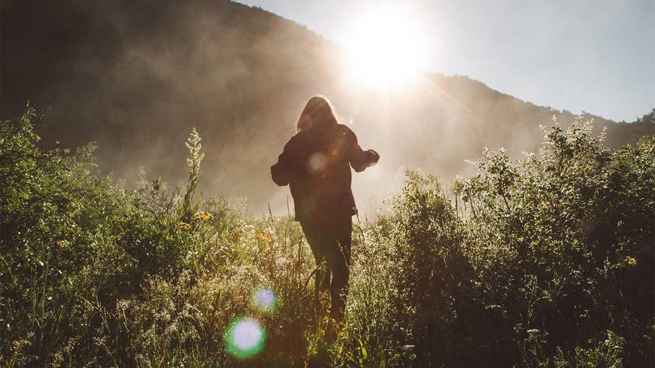 A silhouette of a person walking in nature. Next Avenue, languishing, flourishing