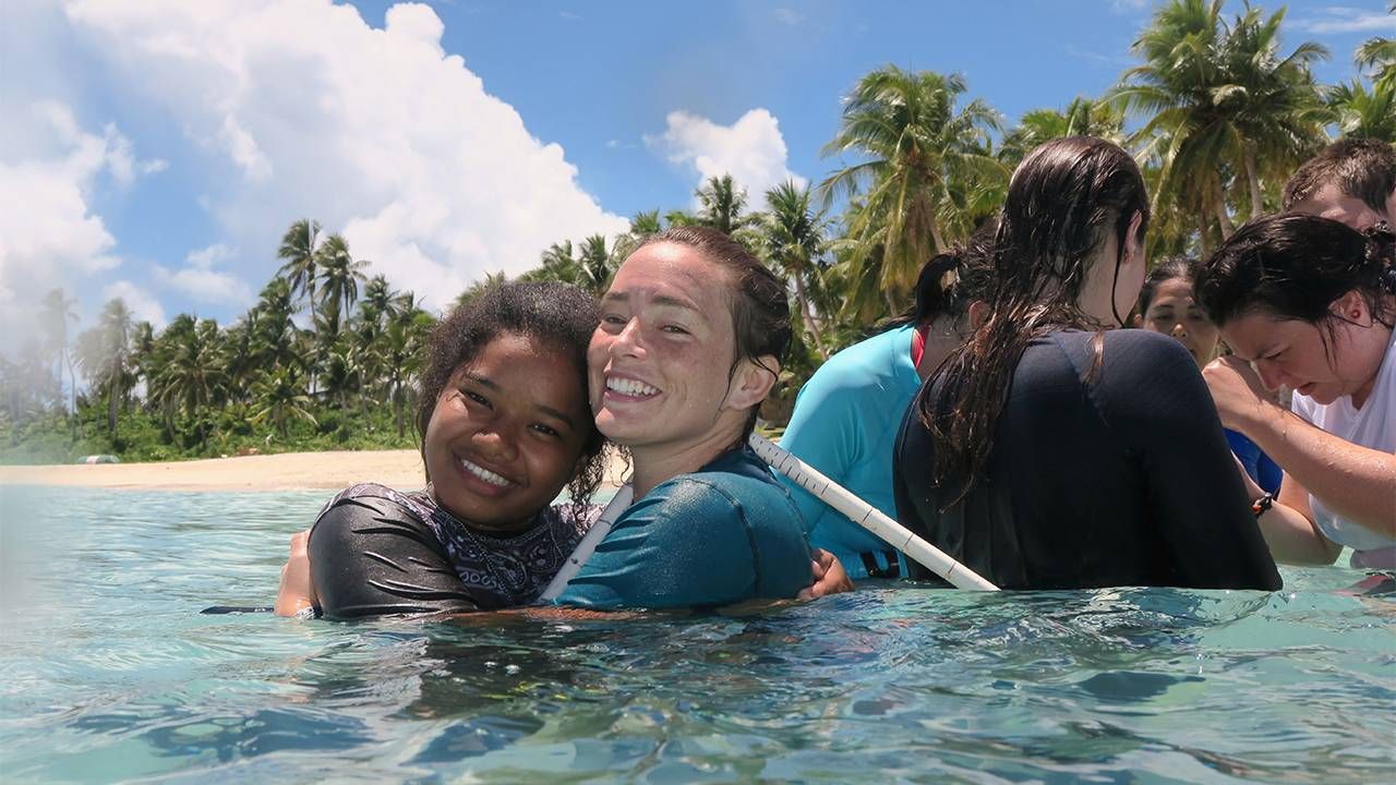 Students in the ocean smiling. Next Avenue, environmentalists, conservation