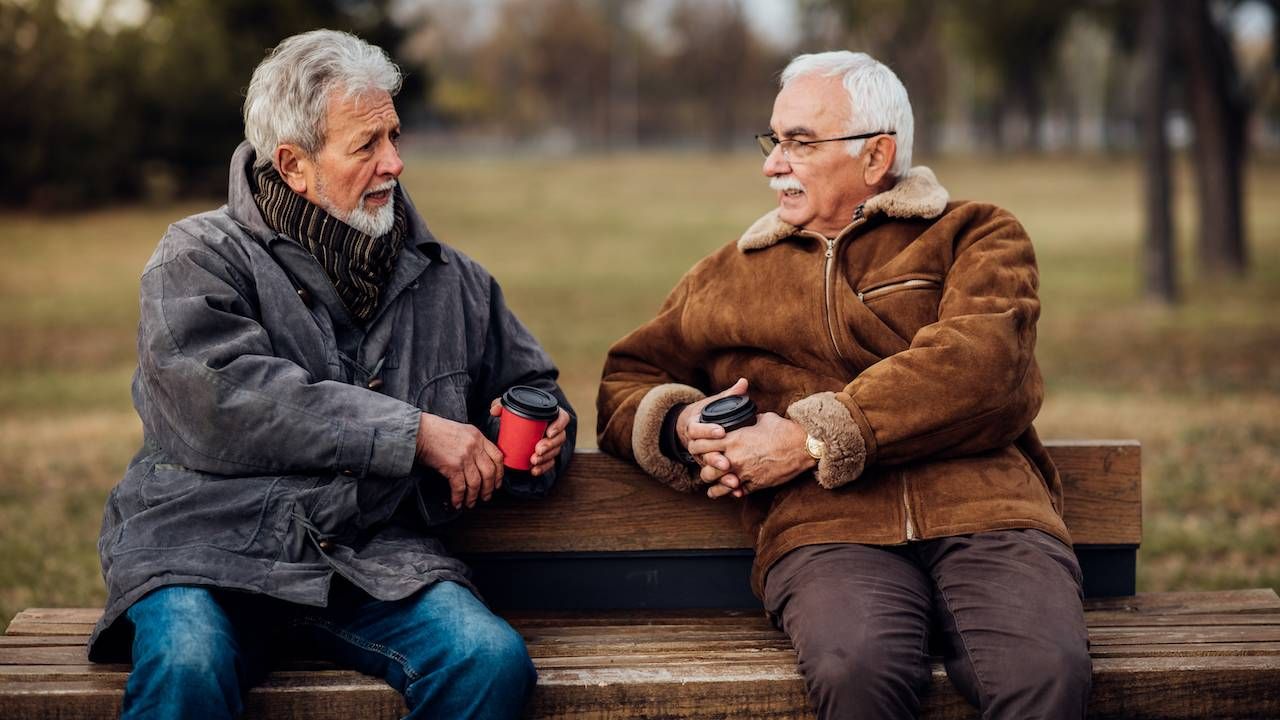 Two men sitting on a bench.