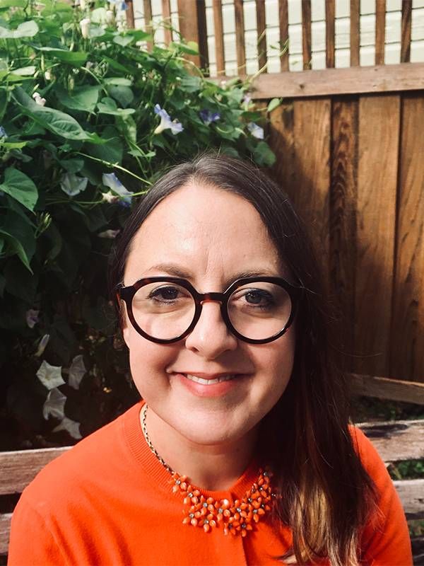 Poet and teaching artist Zoë Bird wearing a red shirt and glasses. Next Avenue Arts and Learning Course, poetry, poem