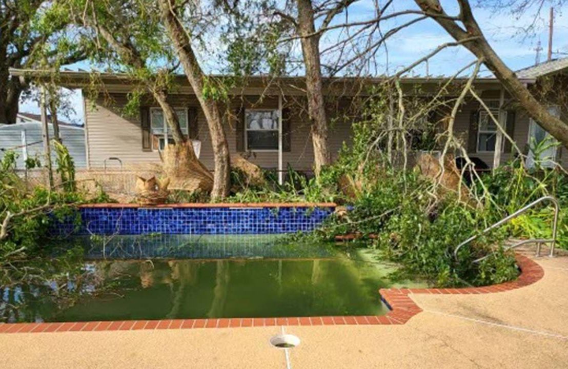 Lori Lyons backyard and pool with fallen tree limbs and debris. Next Avenue, hurricane Ida, new orleans