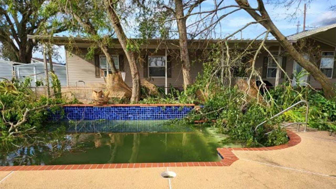 Lori Lyons backyard and pool with fallen tree limbs and debris. Next Avenue, hurricane Ida, new orleans