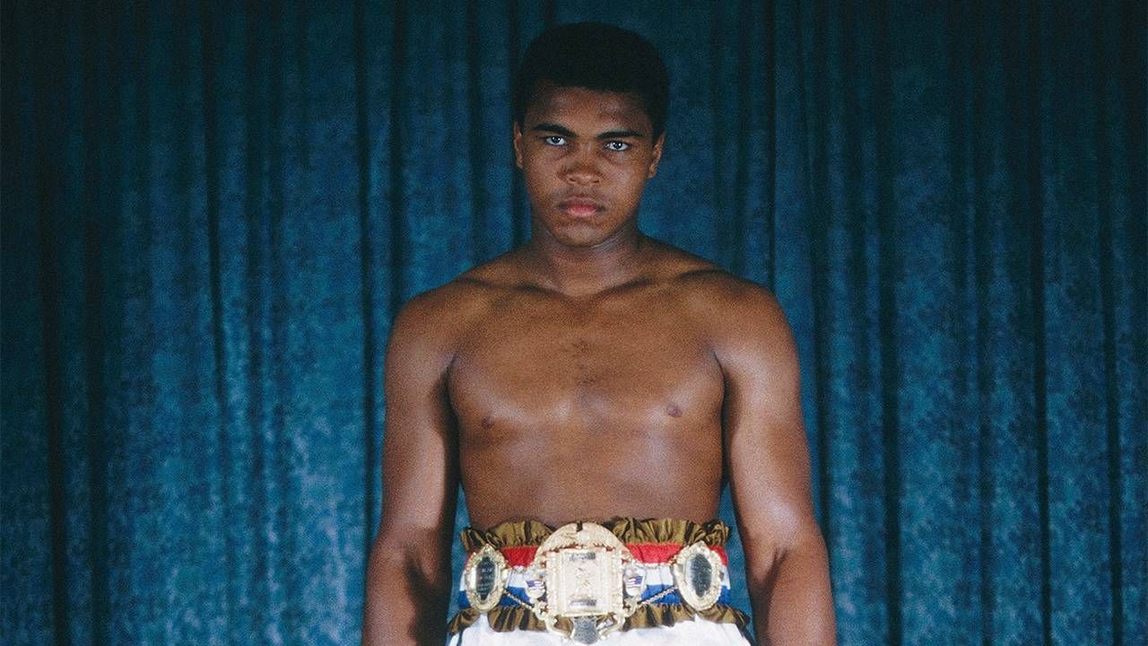 A young Muhammad Ali wearing boxing shorts and a medal around his waist. Next Avenue, Muhammad Ali, PBS