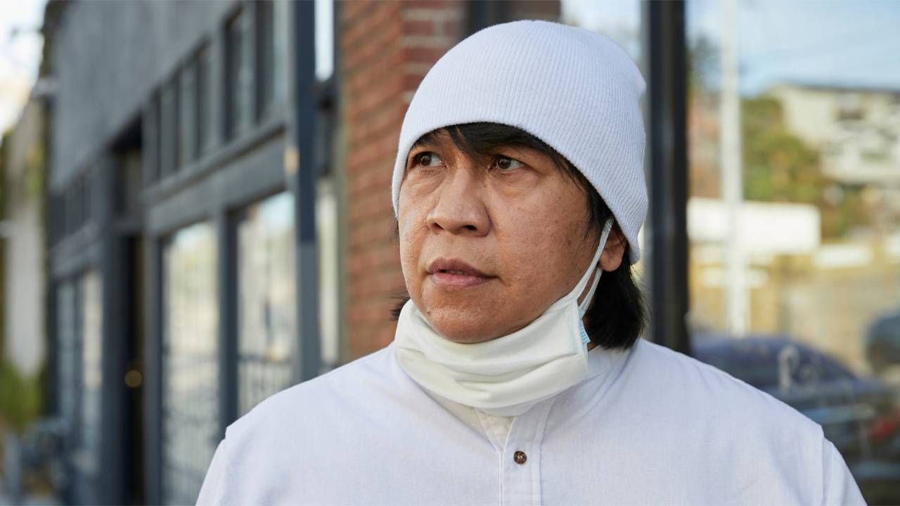 A man wearing a white hat and face mask. Next Avenue, paid caregivers, CNAs, caregiving