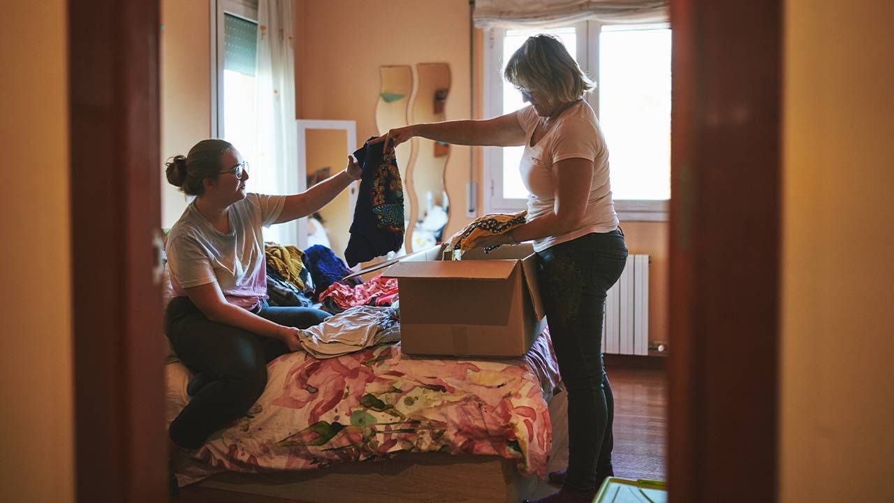 A mother and daughter sorting through clothes. Next Avenue, clothing donation, recycled clothing