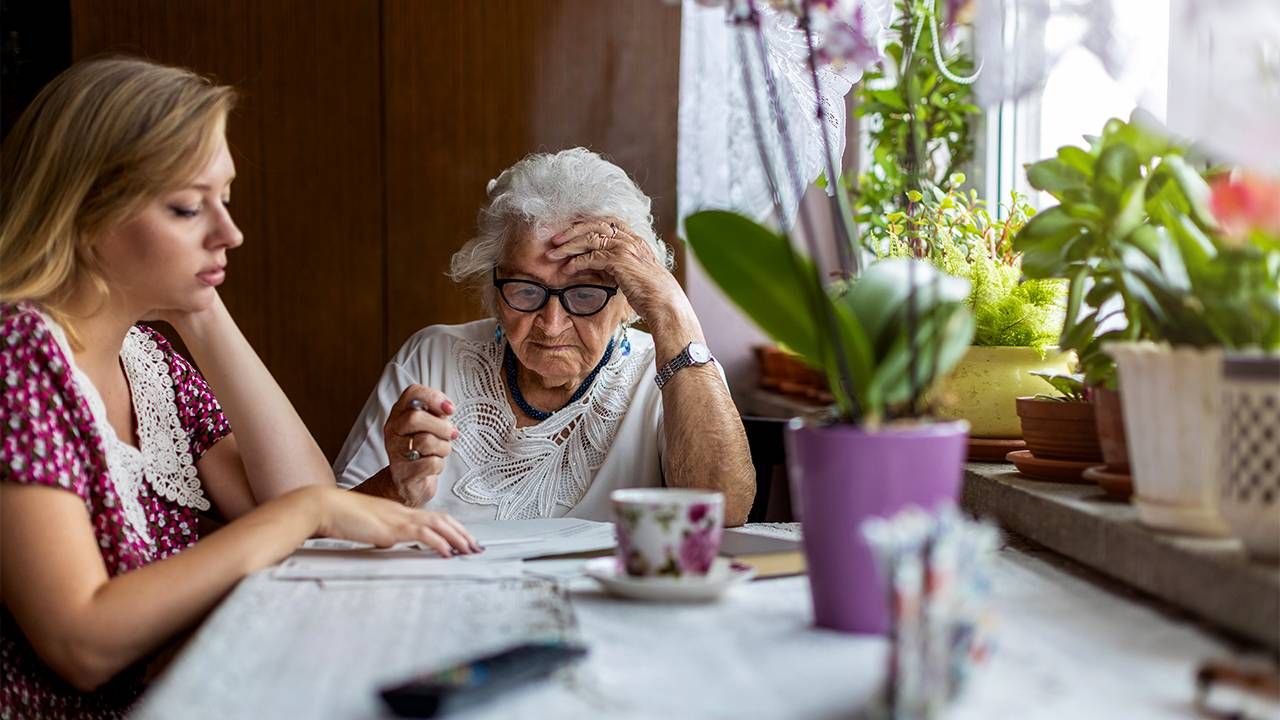 A family caregiver helping her mother with paperwork. Next Avenue, honesty,dementia care, Alzheimer's, tell the truth