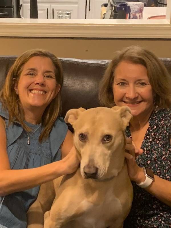 Two women sitting on a couch with a dog. Next Avenue, Hurricane Ida, new orleans