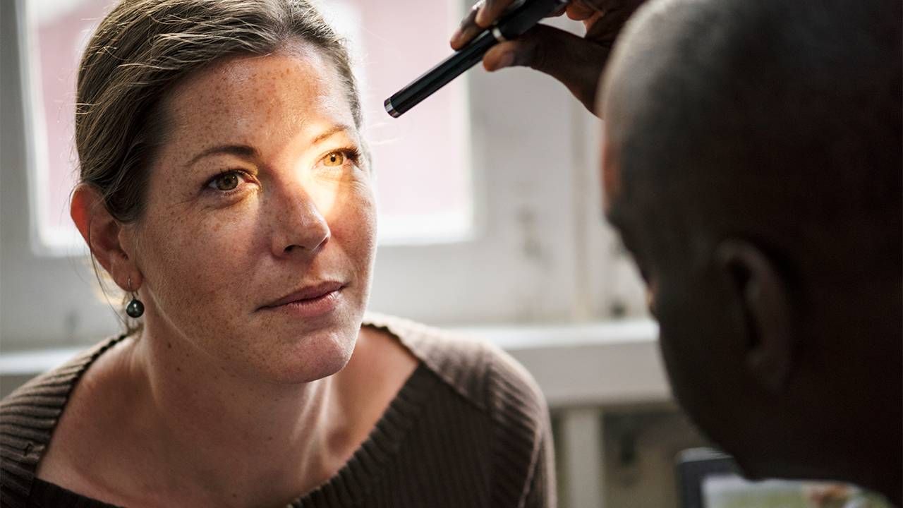 A woman at an eye doctor appointment. Next Avenue, floaters in eye, vitreous