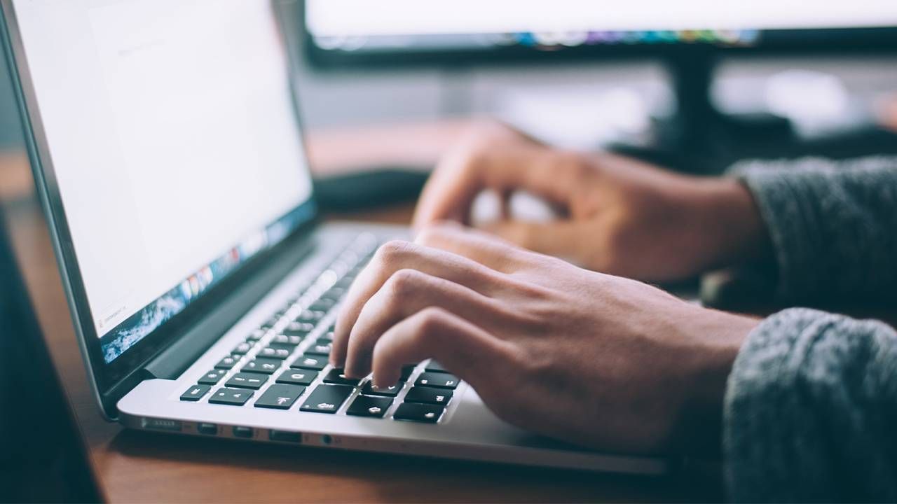 A person writing an email on a laptop. Next Avenue, networking, network