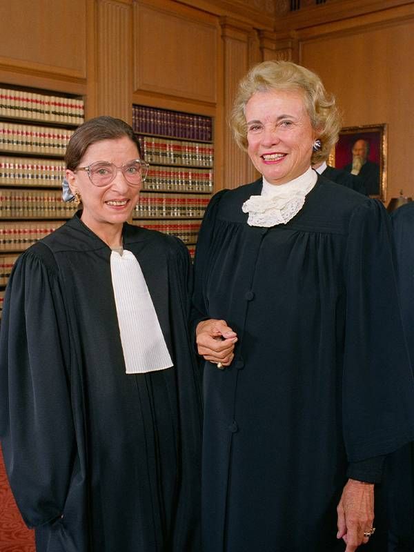 Sandra Day O'Connor standing next to Ruth Bader Ginsburg wearing their robes. Next Avenue, PBS documentary