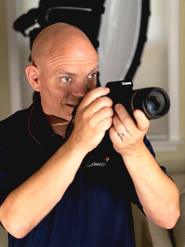 A man holding a camera. Next Avenue, adult education, peer learning