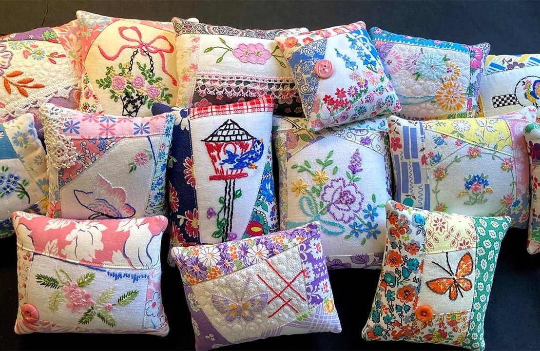 A group of colorful quilted pillows. Next Avenue, vintage, repurposing, crafts