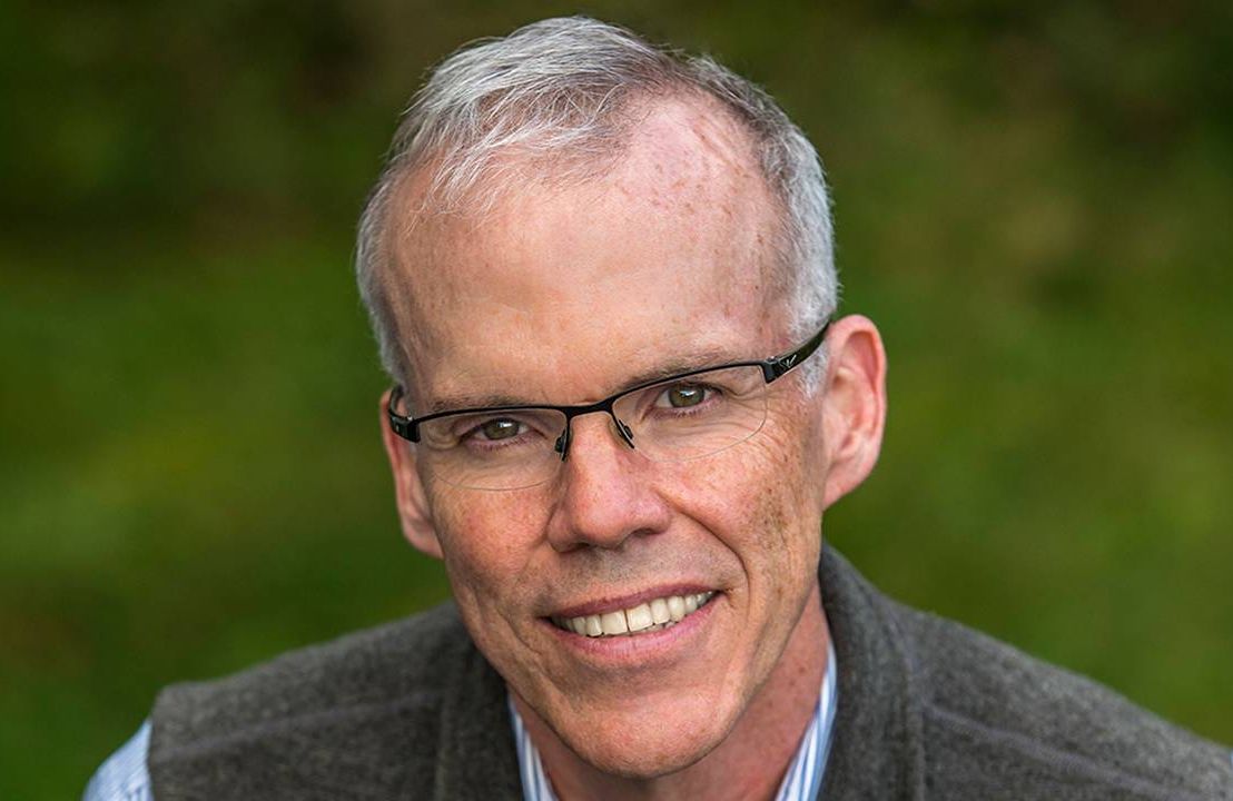 A man wearing a wool vest and shirt smiling while standing outside. Next Avenue, Bill McKibben, environmentalist, Third Act