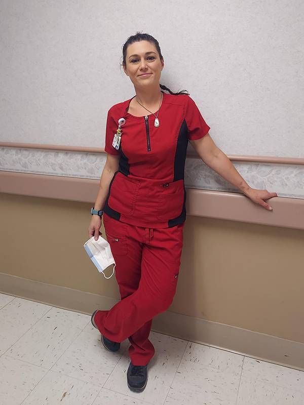 A young CNA health care worker wearing a hospital badge. Next Avenue