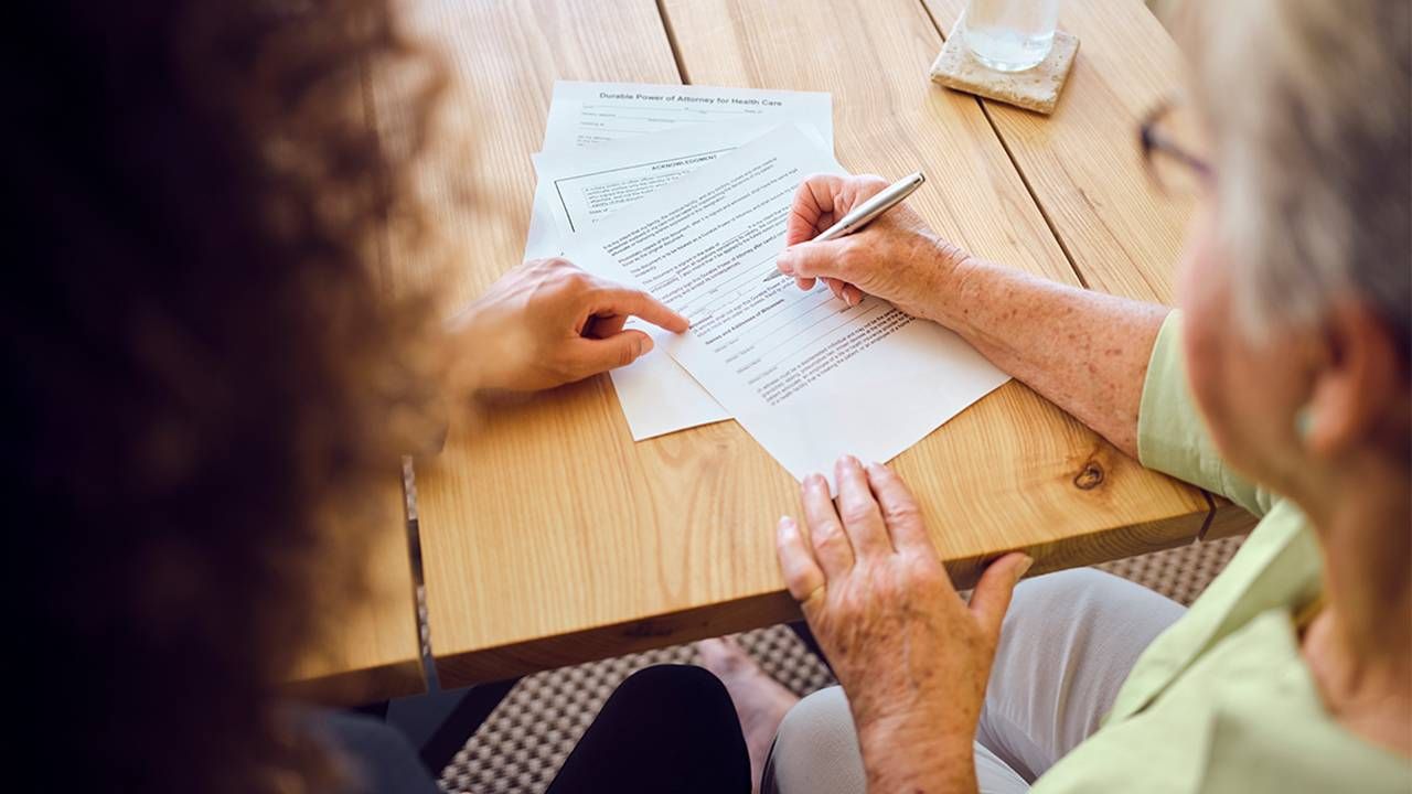 A person signing their last will and testament. Next Avenue, estate planning mistakes