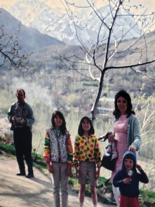 A family smiling while walking up a mountain. Next Avenue, Family trip, Afghanistan, Kabul