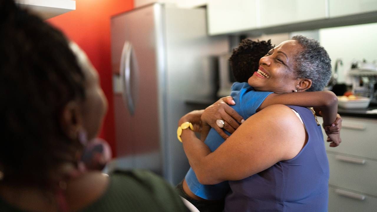 A woman embracing her grandchild who is happy in her retirement. Next Avenue