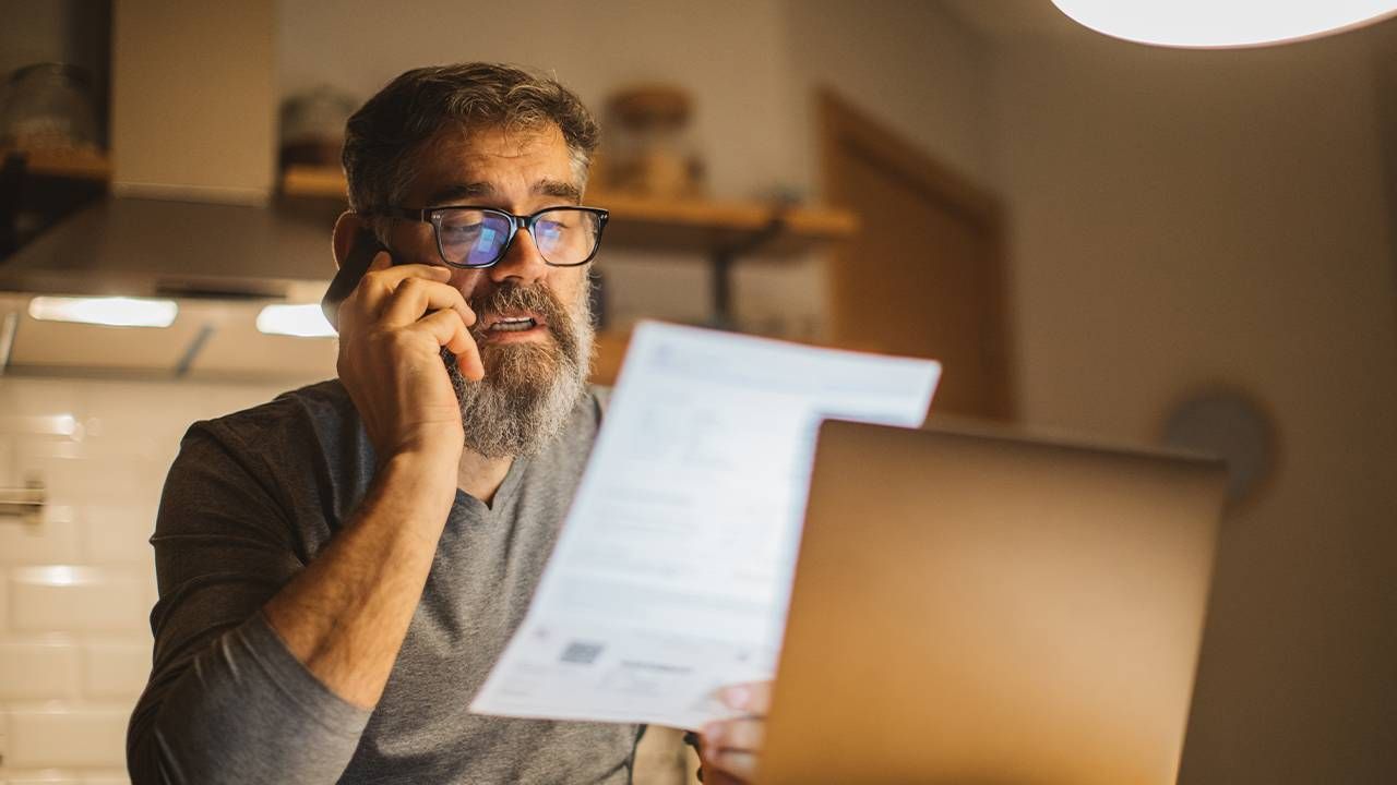 A man paying for a medical bill. Next Avenue, health insurance claim, medical bill, denied claim