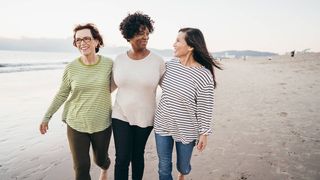 A group of friends walking on the beach. Next Avenue, menopause symtopms