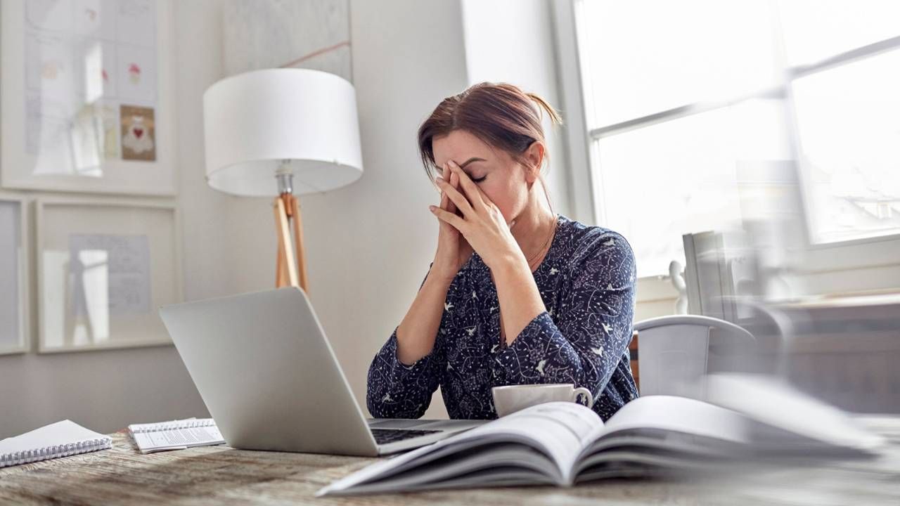 A woman looking upset while on her laptop. Next Avenue