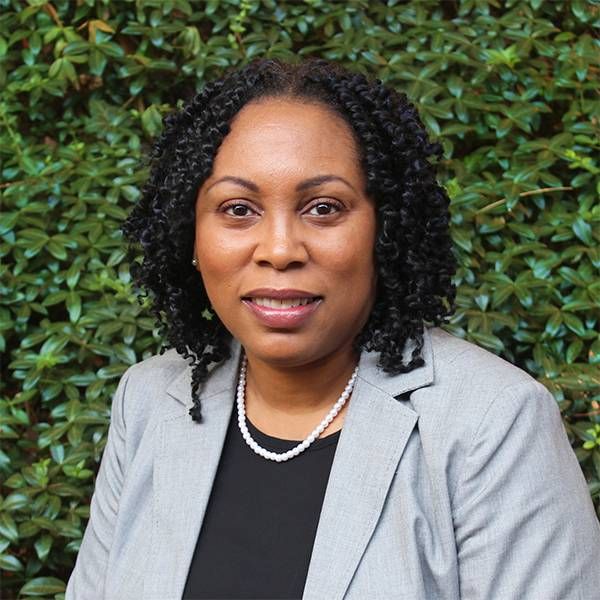 Headshot a woman wearing a suit jacket. of a Next Avenue