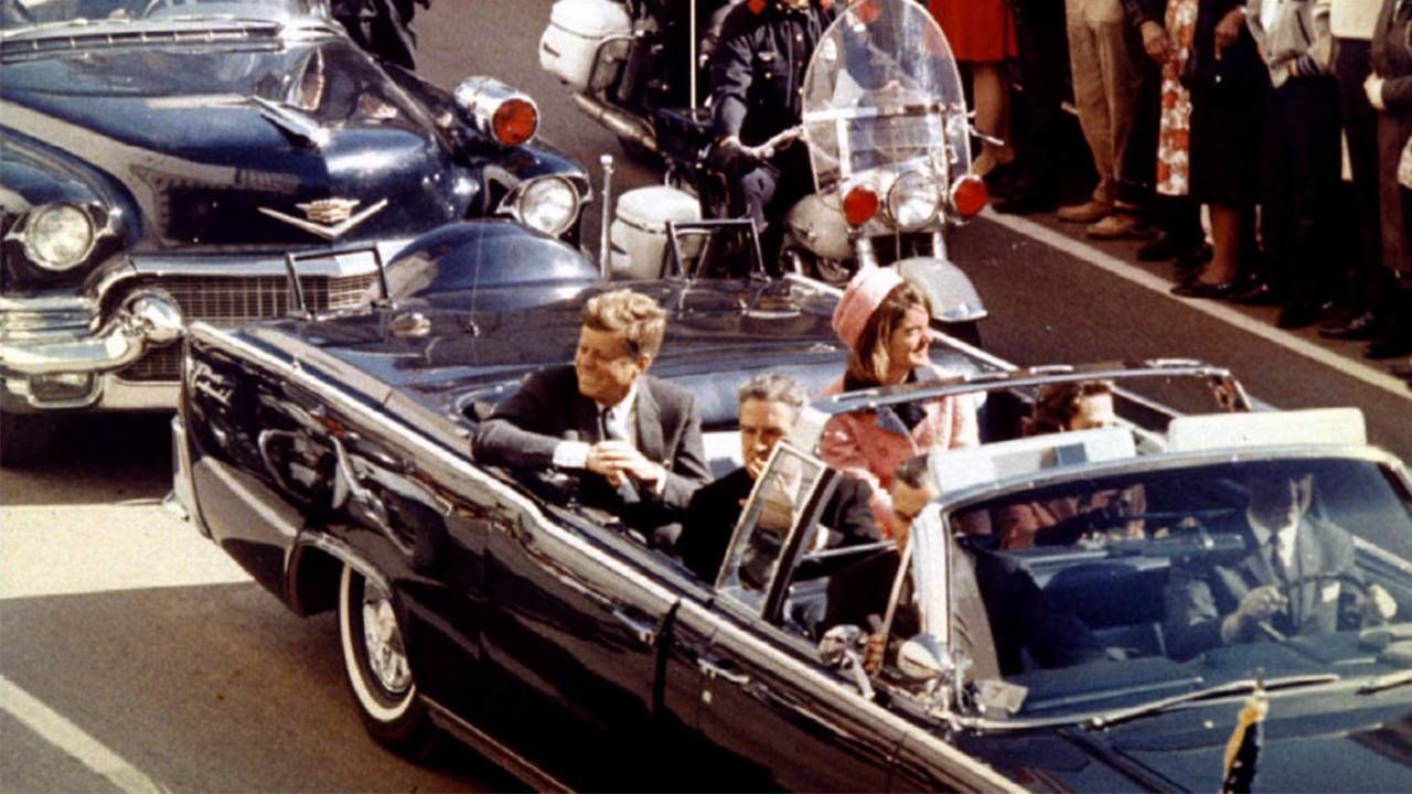 President and Mrs. John F. Kennedy riding in a car in Dallas. Next Avenue