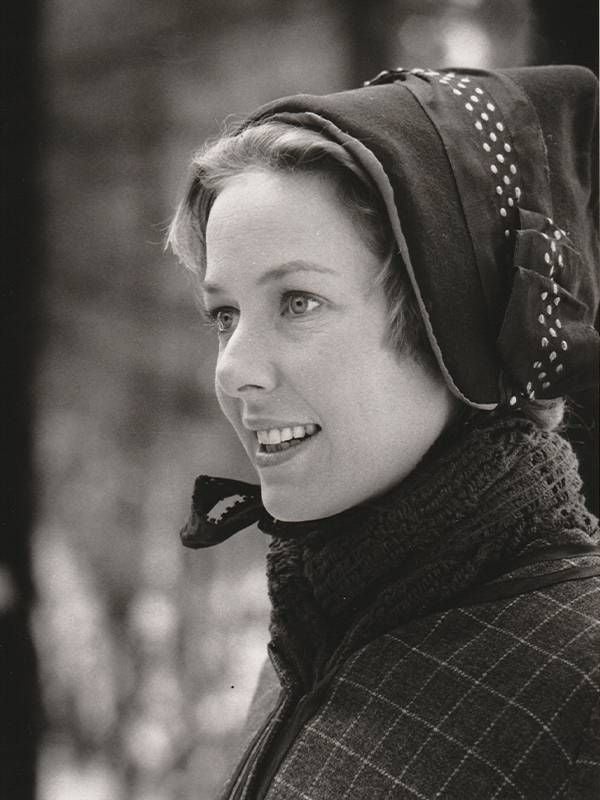 A black and white photo of a young woman wearing a bonnet and scarf. Next Avenue, Karen Grassle, Little House on the Prairie