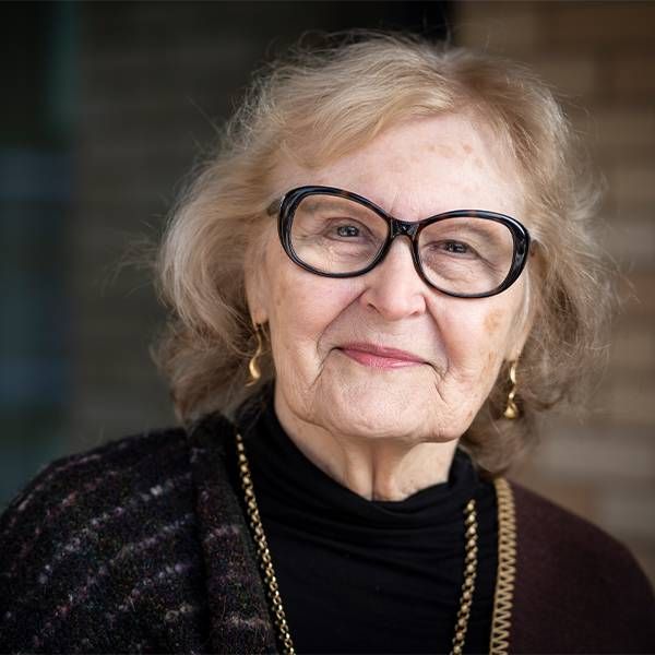 Headshot of a woman with gold jewelry and a black turtleneck. Next Avenue