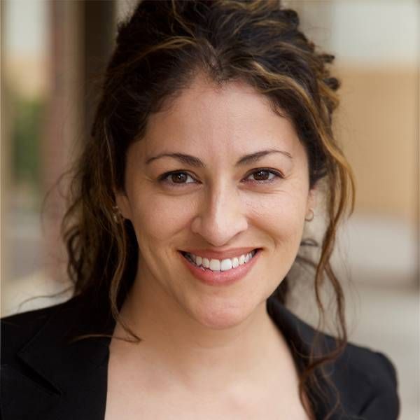 A headshot of a woman outside smiling. Next Avenue